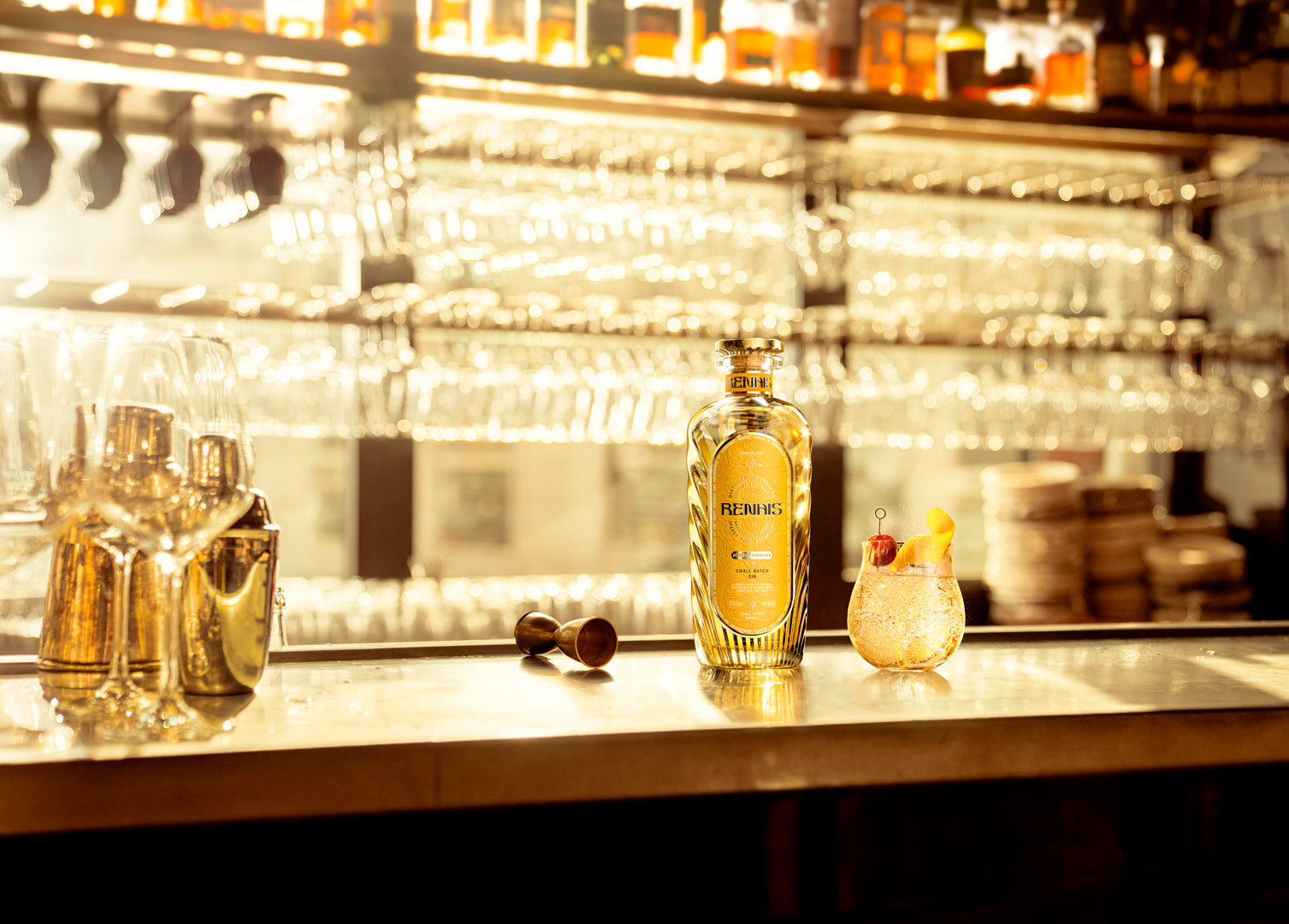 Renais bottle and cocktail on a softly lit back bar