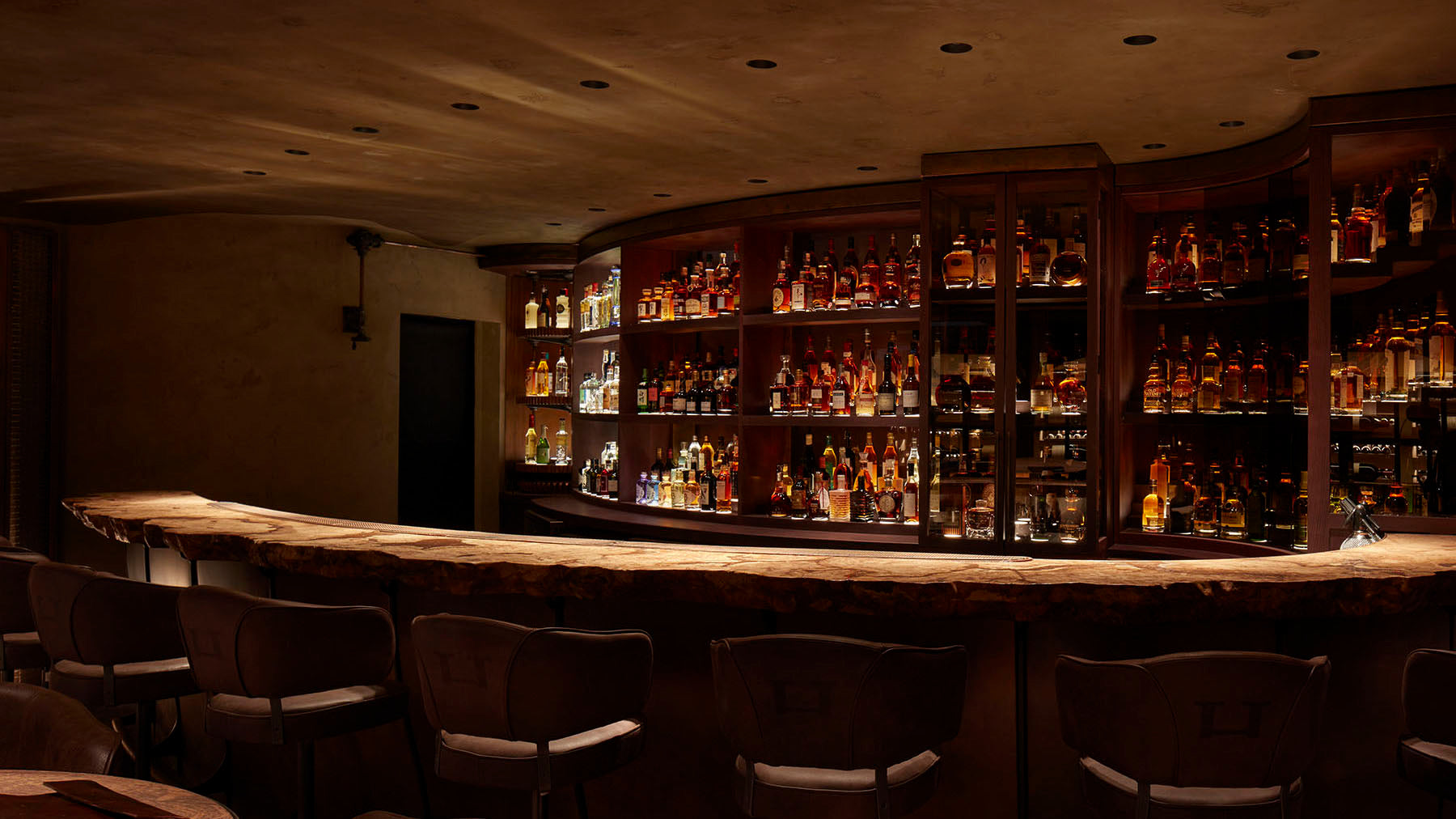 The warm wood bar and back bar at Hide in London